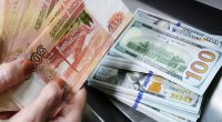 ABŞ dollarının məzənnəsi 100 rubldan aşağı düşdü - Rusiyada